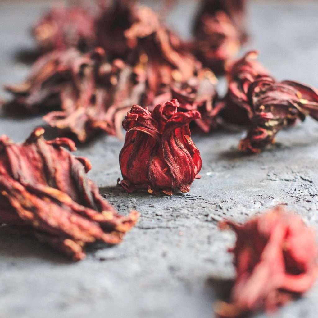 Onenqui imperial cider background image of dried roselle calyxes